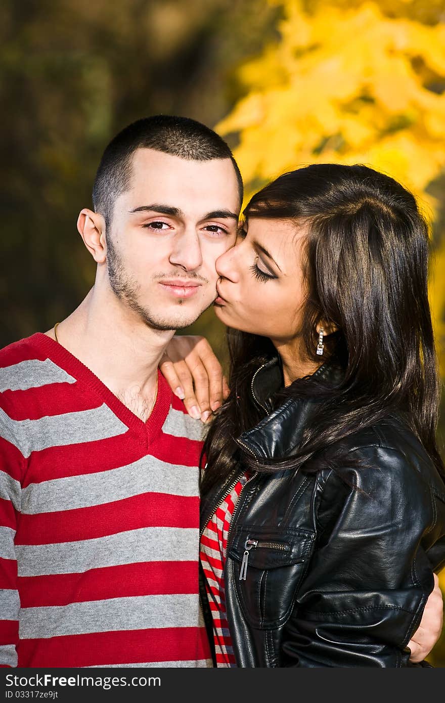 Couple of young lovers are walking in the autumn park. Couple of young lovers are walking in the autumn park