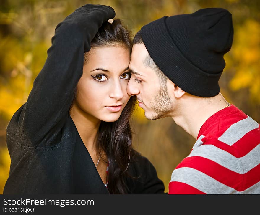 Couple of young lovers are walking in the autumn park. Couple of young lovers are walking in the autumn park