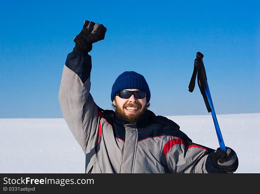 Portrait of handsome skier in the snowy field