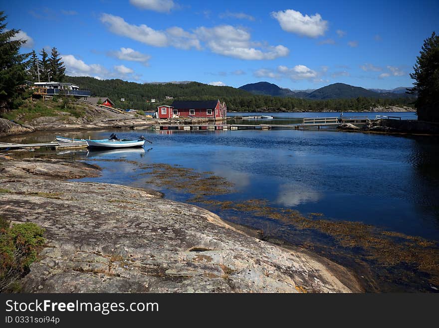 Beautiful nordic landscape, with boats, boaethouses and pier. Shot in sunny beautifull day. Beautiful nordic landscape, with boats, boaethouses and pier. Shot in sunny beautifull day.