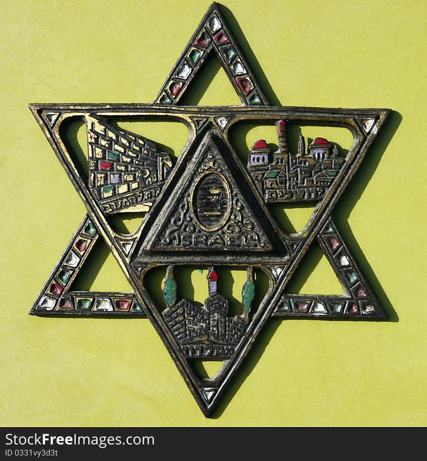 Antique decorative metal colorful star of David on light background.Jerusalem fleamarket. Antique decorative metal colorful star of David on light background.Jerusalem fleamarket.