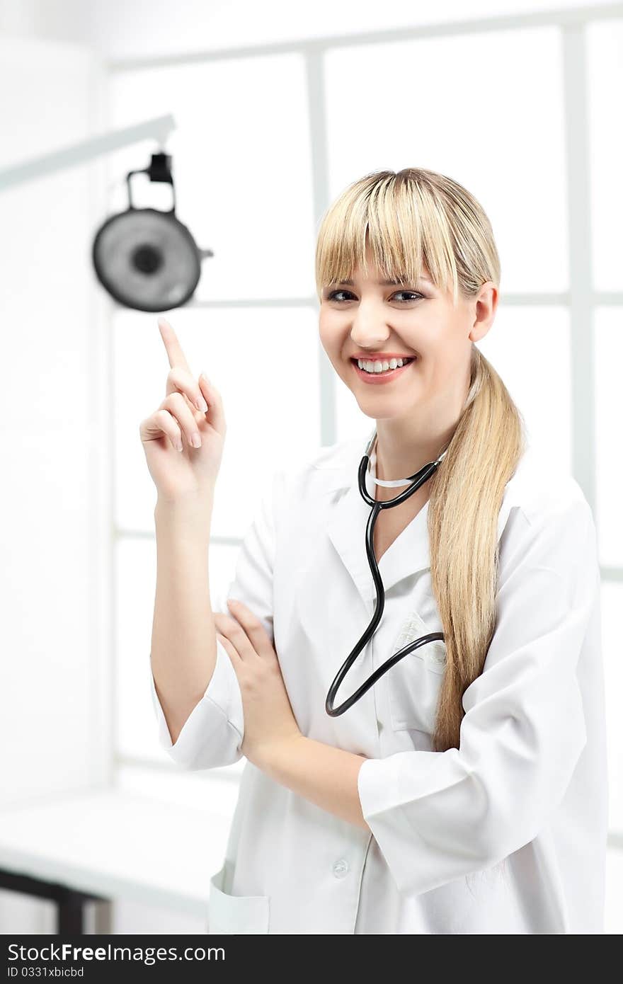 Woman doctor with blond hair in white. Woman doctor with blond hair in white