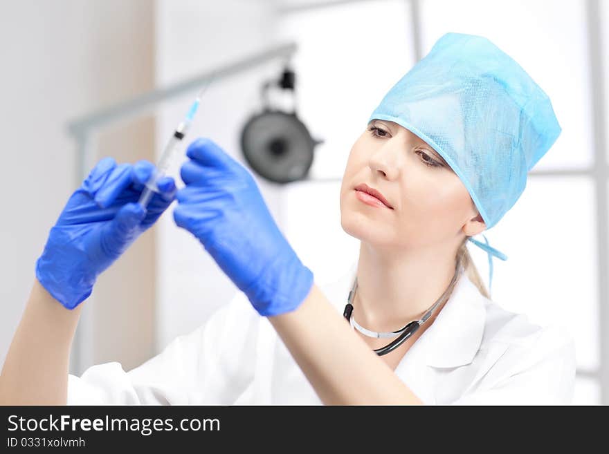 Woman doctor with blond hair in white. Woman doctor with blond hair in white