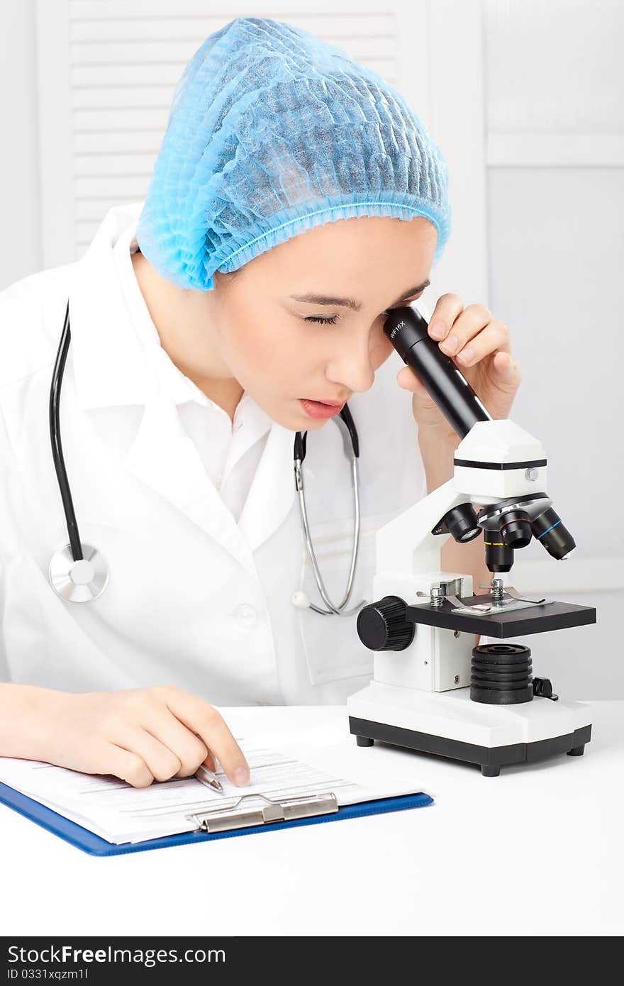 Medical - Female Nurse Looking In Microscope