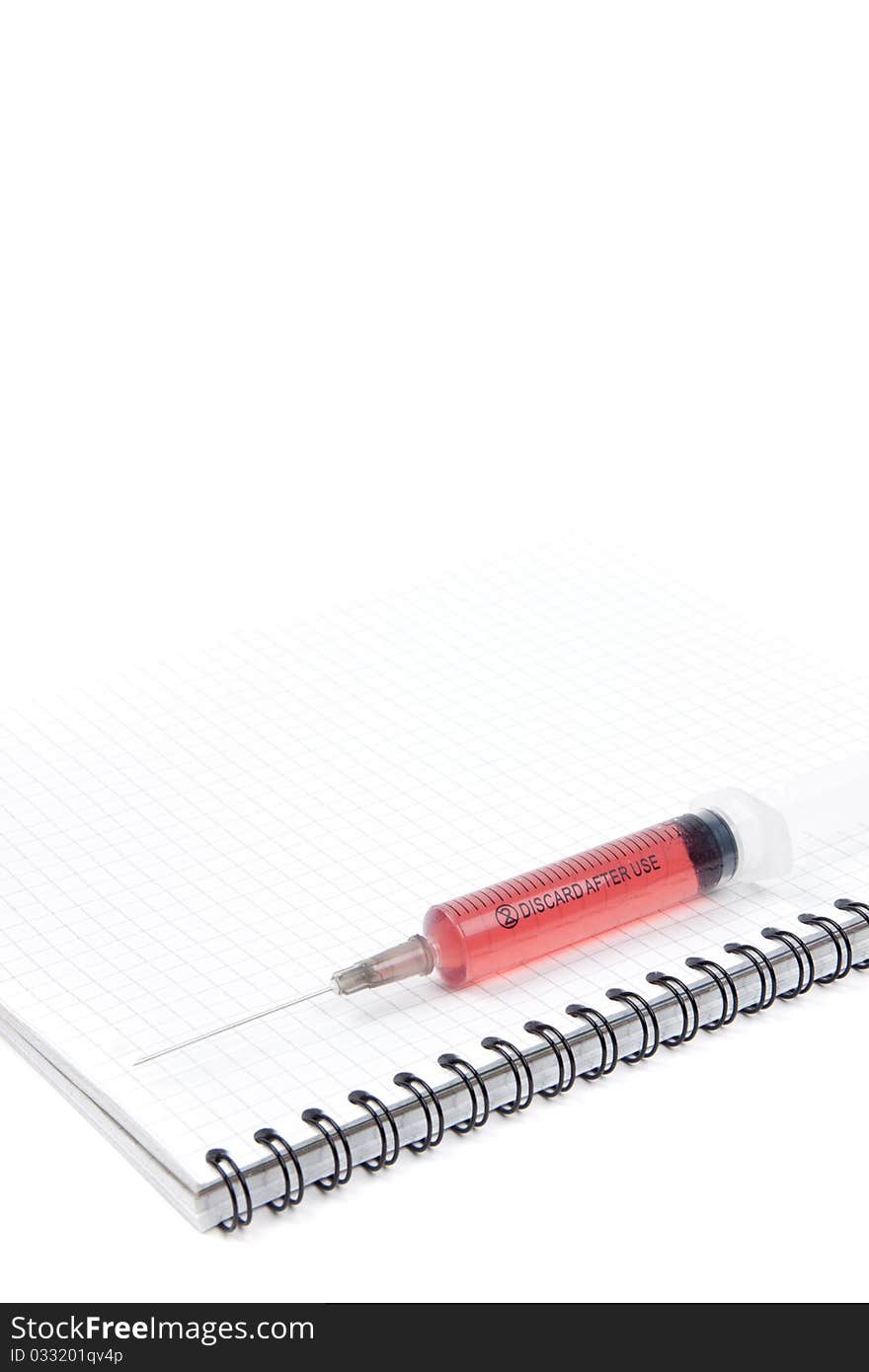 Syringe on a notebook