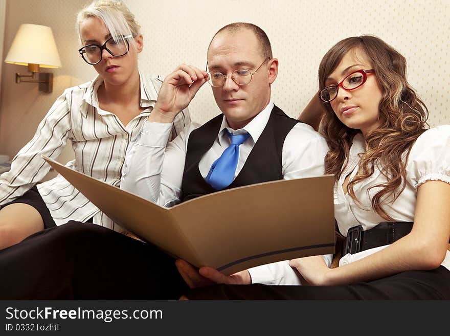 Portrait of confident associates looking at business document