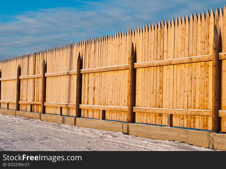 Wooden roadside fence at winter season. Wooden roadside fence at winter season