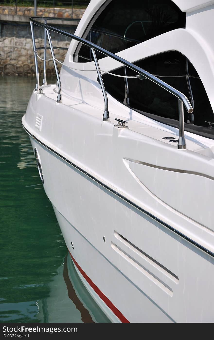 Body of a white yacht which stop in harbor, shown as marine activity, travel or in maintenance. Body of a white yacht which stop in harbor, shown as marine activity, travel or in maintenance.