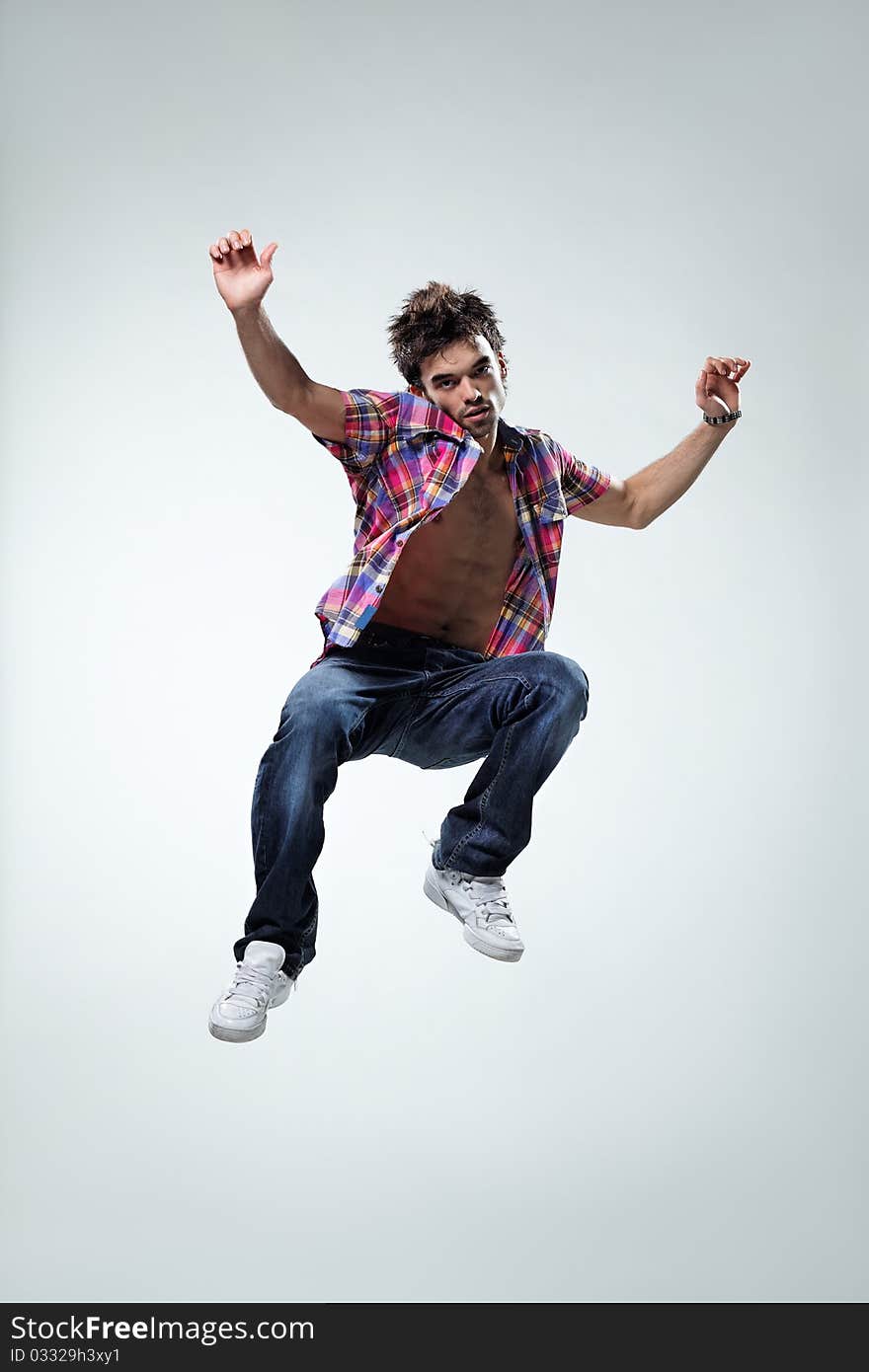 Modern style dancer jumping on studio background. Modern style dancer jumping on studio background