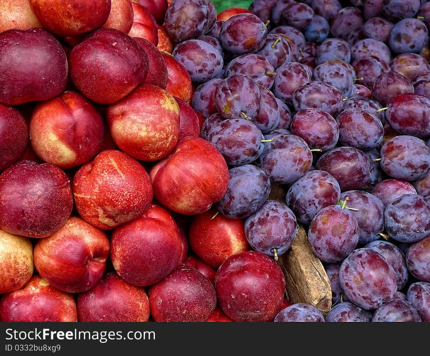 Plums and nectarines at an outdoor market in Paris France. Plums and nectarines at an outdoor market in Paris France