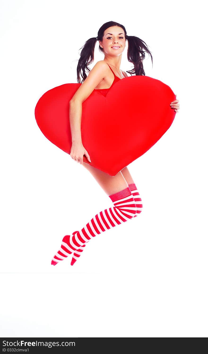 Sexy young jumping woman with a big heart in her hands. Sexy young jumping woman with a big heart in her hands