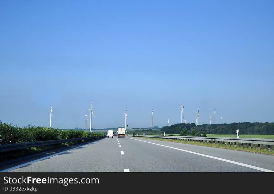 Highway and wind turbines in the foreground