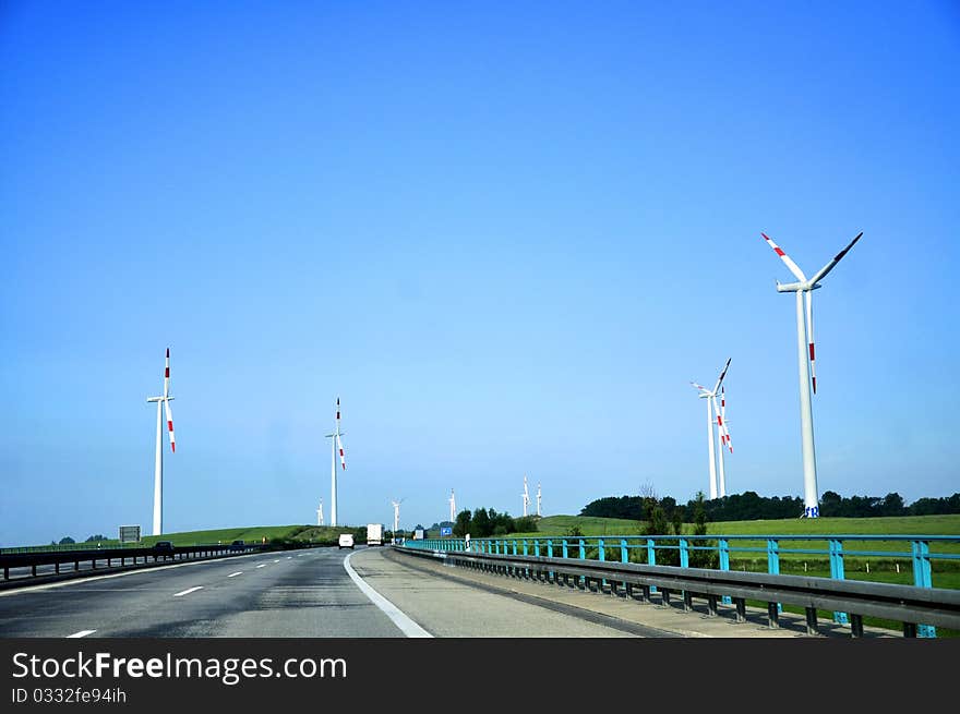 Highway and wind turbines in the foreground