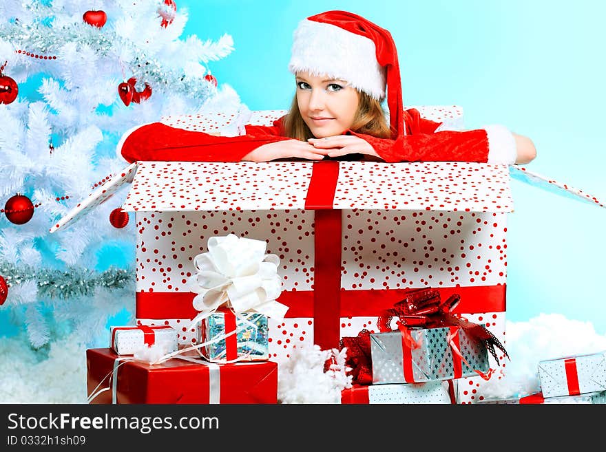 Beautiful young woman in Santa Claus clothes over Christmas background. Beautiful young woman in Santa Claus clothes over Christmas background.