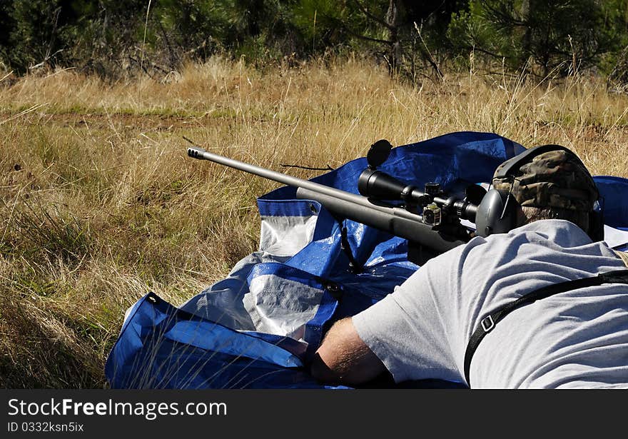 Close up image of male shooting rifle. Close up image of male shooting rifle