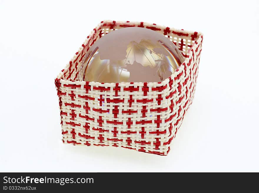 A basket of red and white with world crystal globe isolated in white