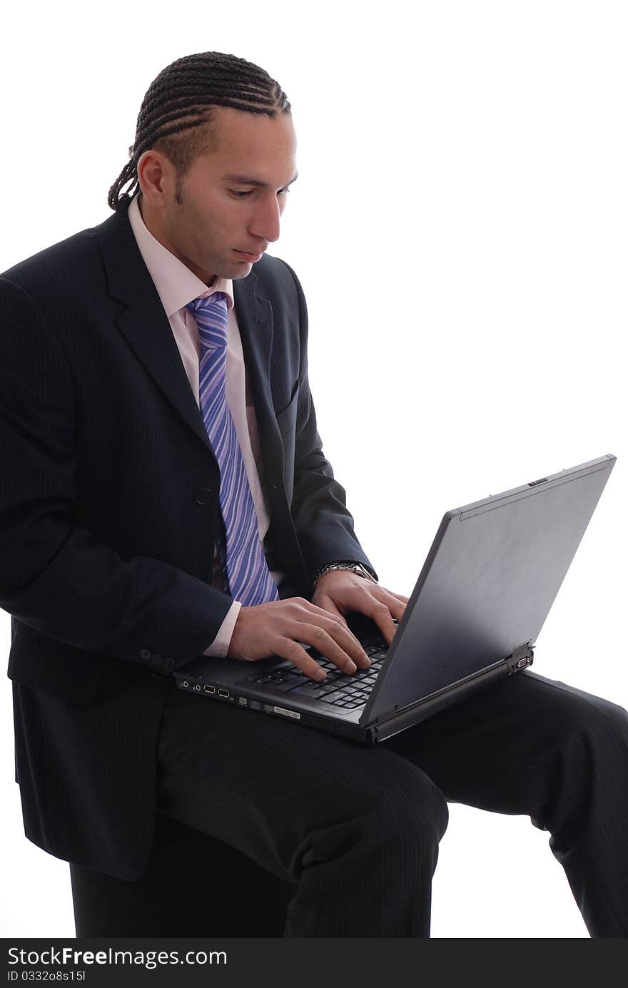 Photograph showing young business man isolated against white on laptop computer