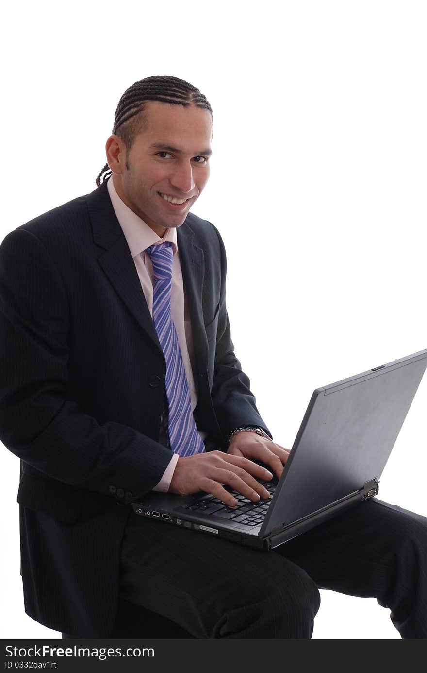 Photograph showing young business man isolated against white on laptop computer