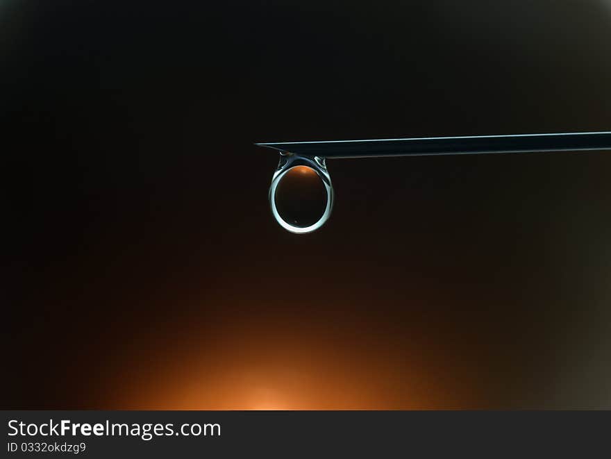 Orange reflection in a drop of water in a black background