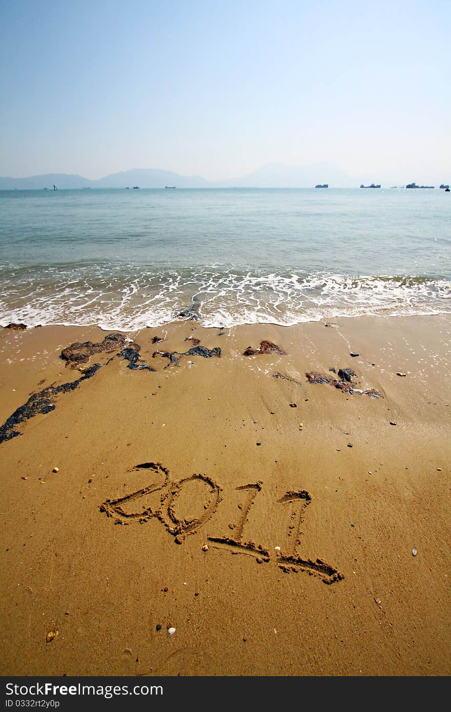 2011, a new year word on sand. 2011, a new year word on sand.