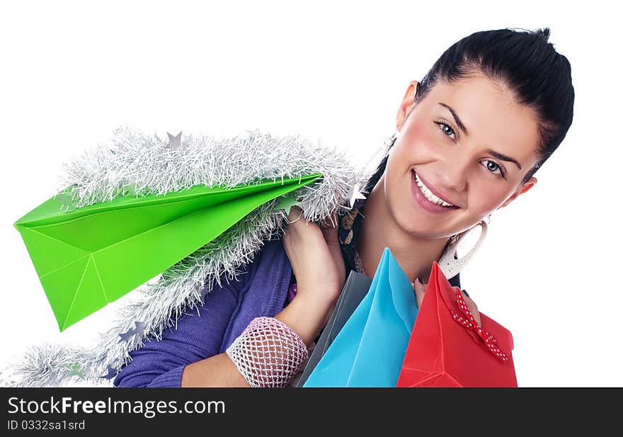 Happy girl with christmas decorations and bags, isolated. Happy girl with christmas decorations and bags, isolated