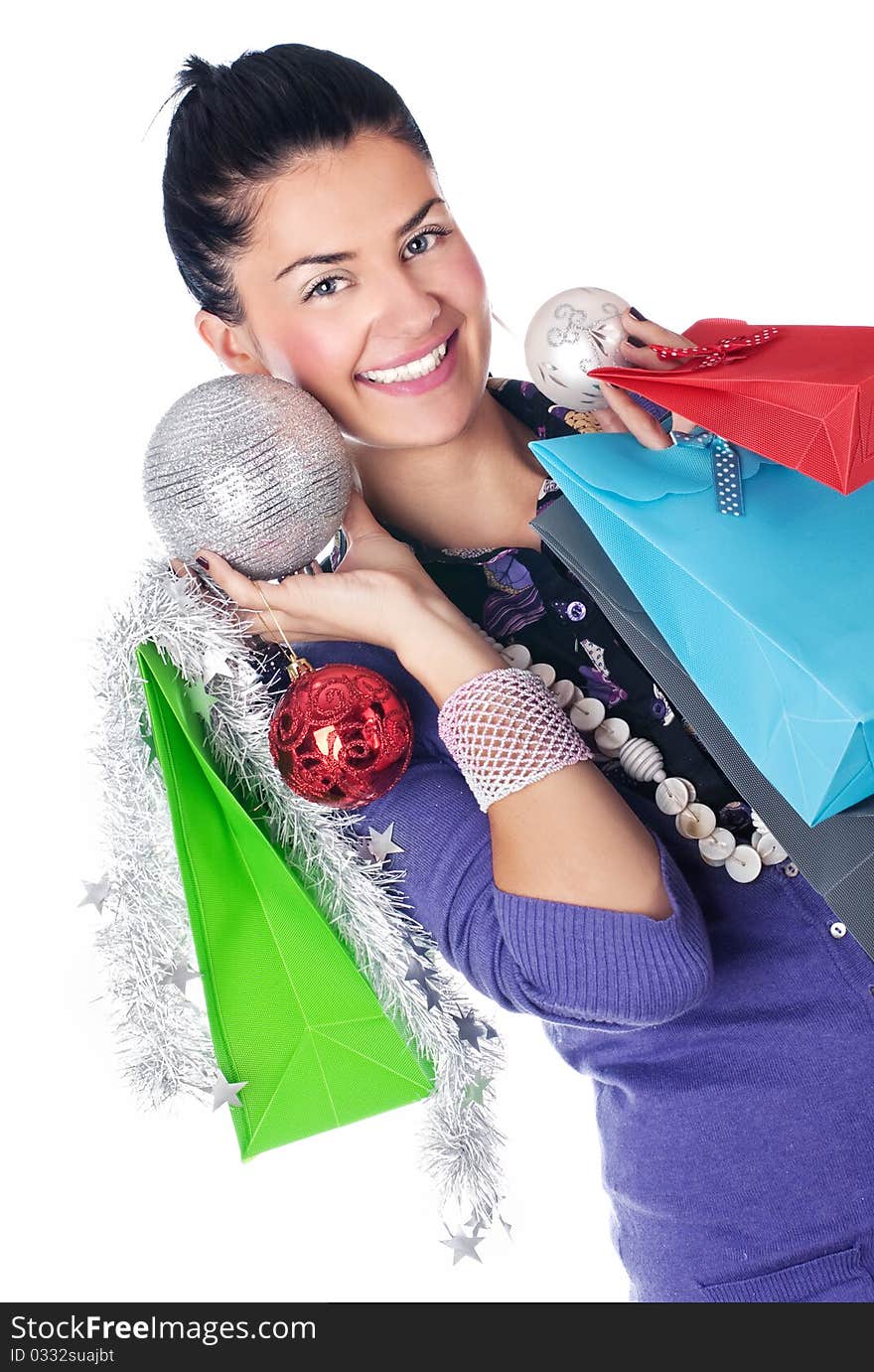 Happy girl with christmas decorations and bags, isolated. Happy girl with christmas decorations and bags, isolated