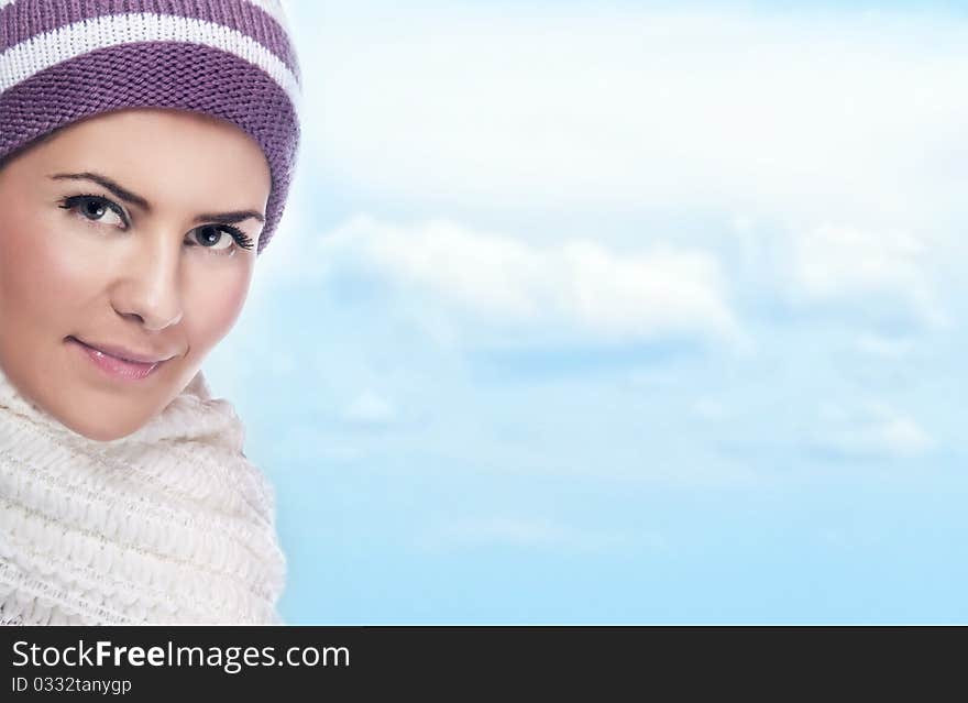 Beautiful young woman in warm clothing, sky at background. Beautiful young woman in warm clothing, sky at background