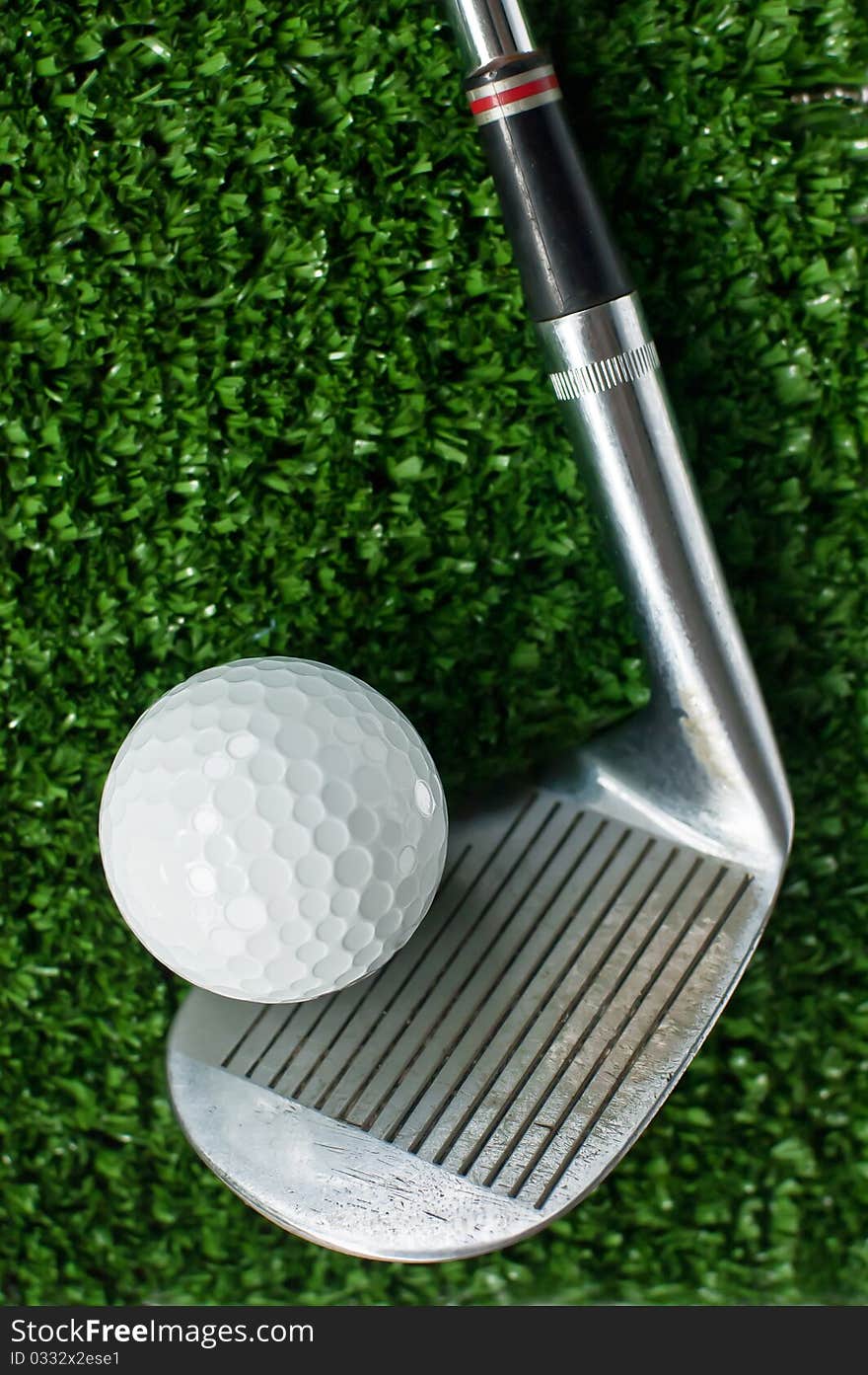 Golf Ball And Putter On Green Grass