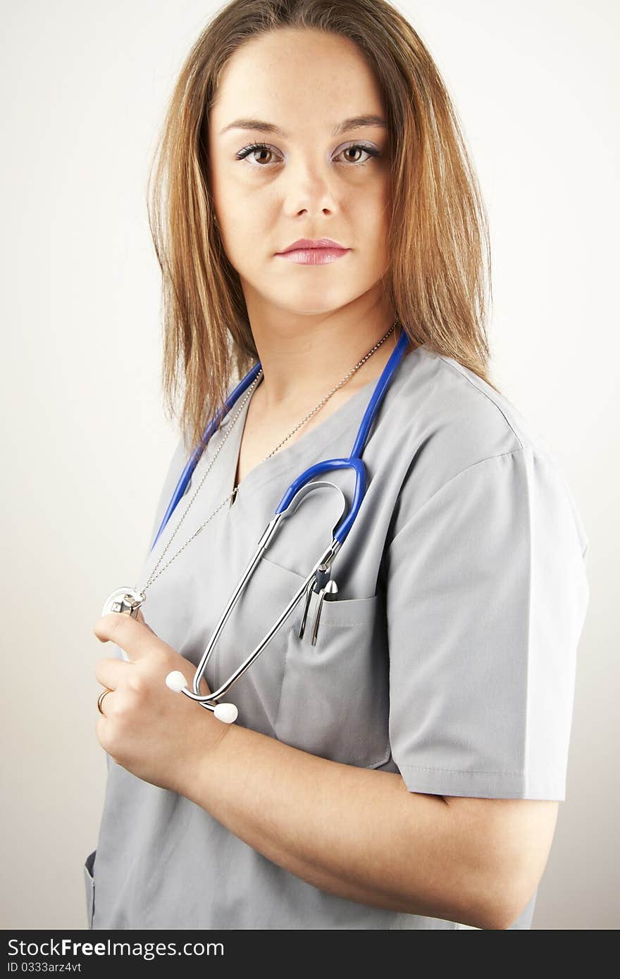 Young woman doctor or nurse wearing gray scrubs