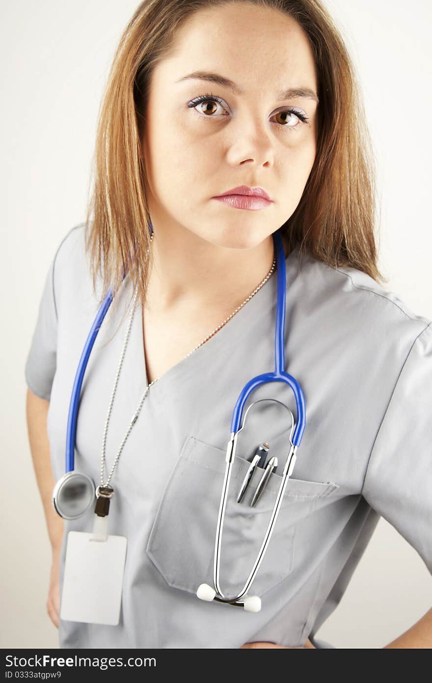 Young woman doctor or nurse wearing gray scrubs