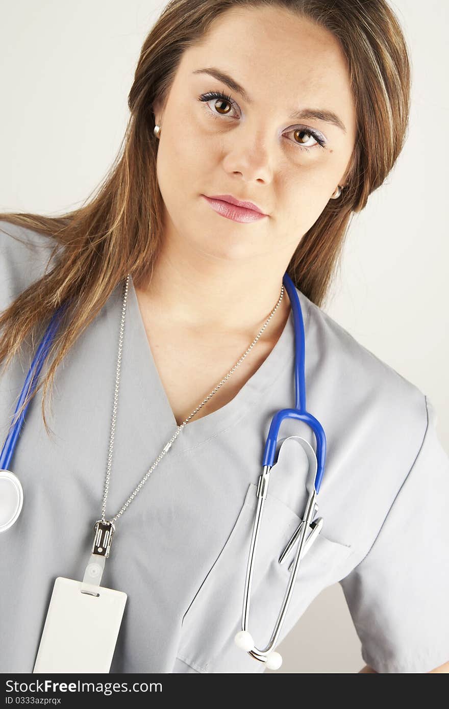 Young woman doctor or nurse wearing gray scrubs