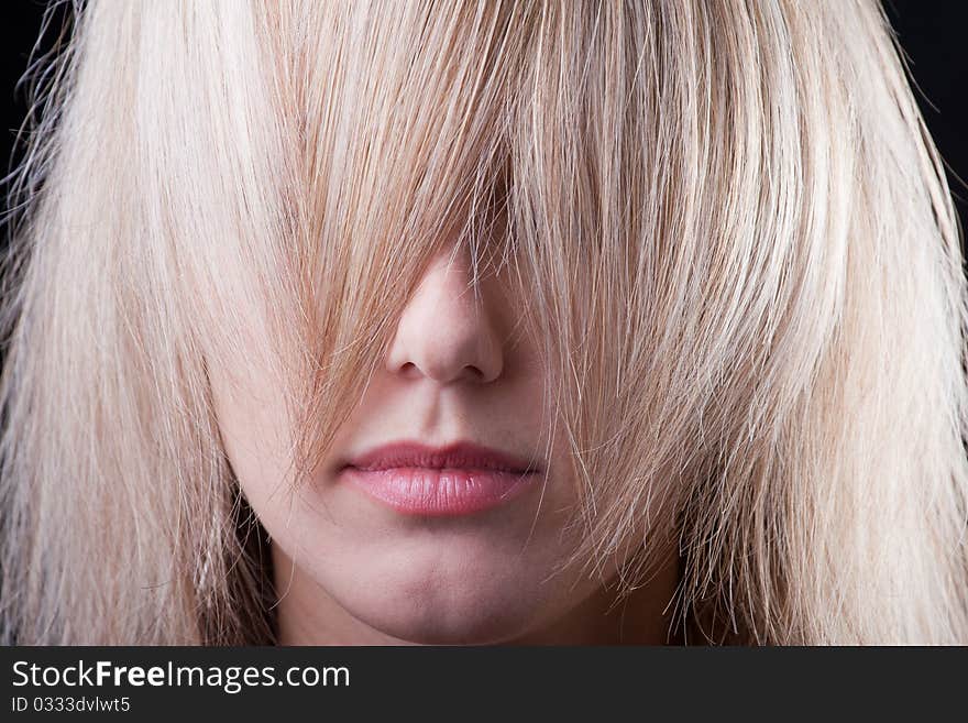 Beautiful girl hiding in a strand of hair