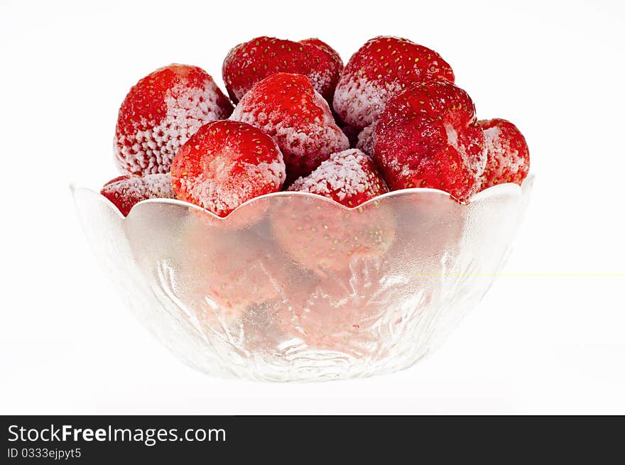 Strawberry sliced in a glass holder, isolated on white background