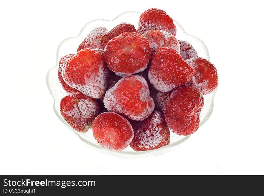 Strawberry sliced in a glass holder, isolated on white background