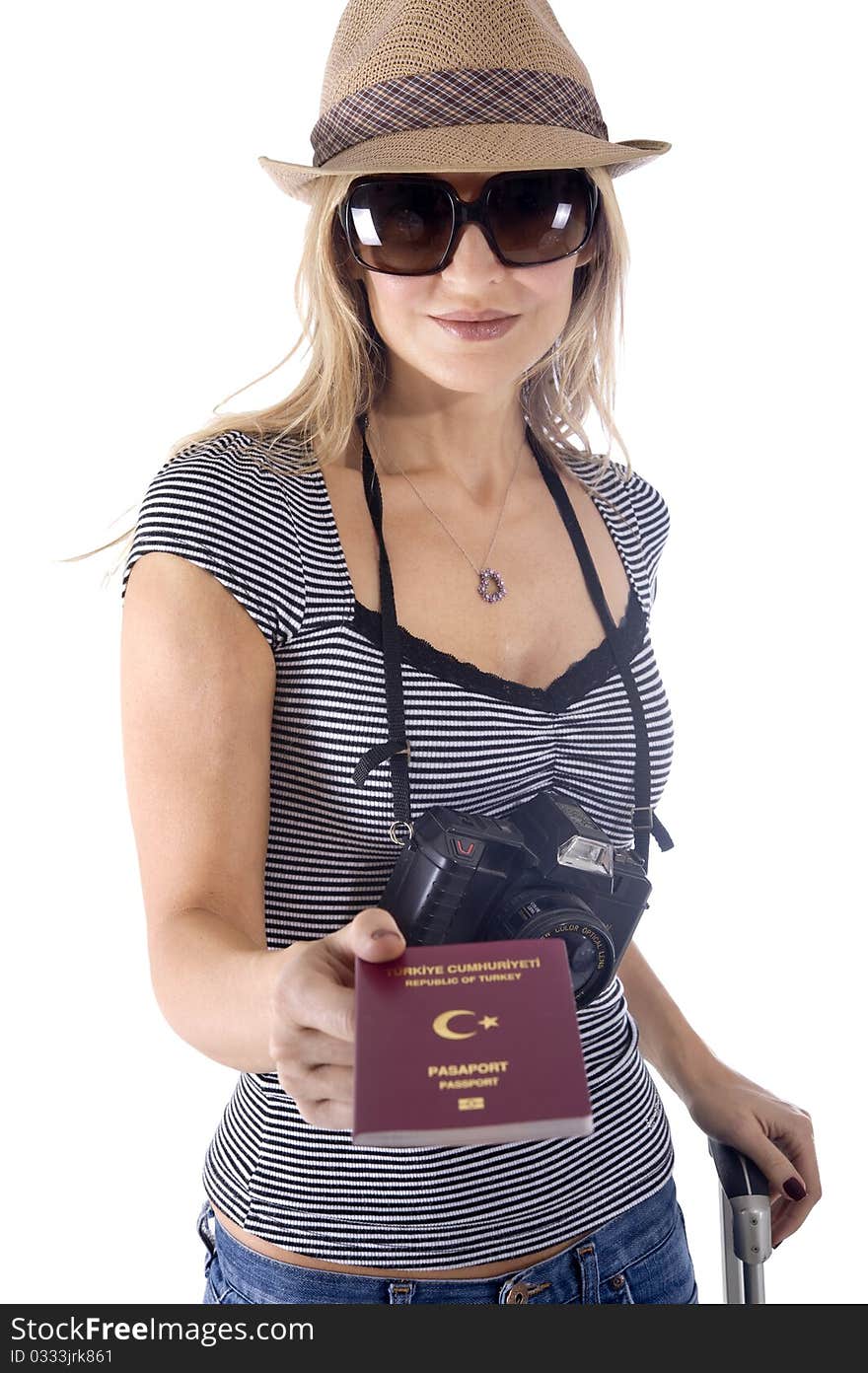 Smiling tourist woman with her camera, hat, and sunglasses showing her passport. Smiling tourist woman with her camera, hat, and sunglasses showing her passport