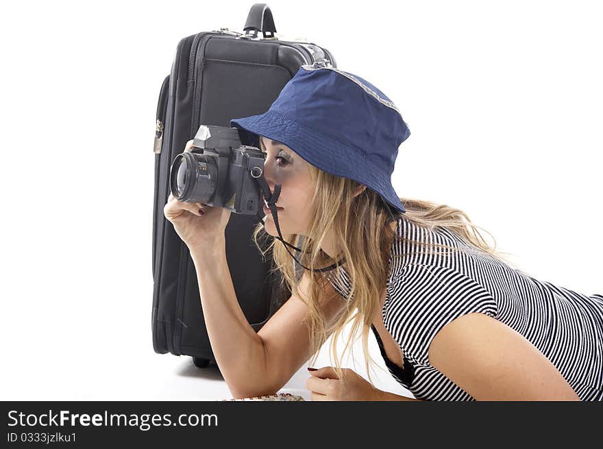 Smiling tourist woman with her suitcase taking photograhs. Smiling tourist woman with her suitcase taking photograhs