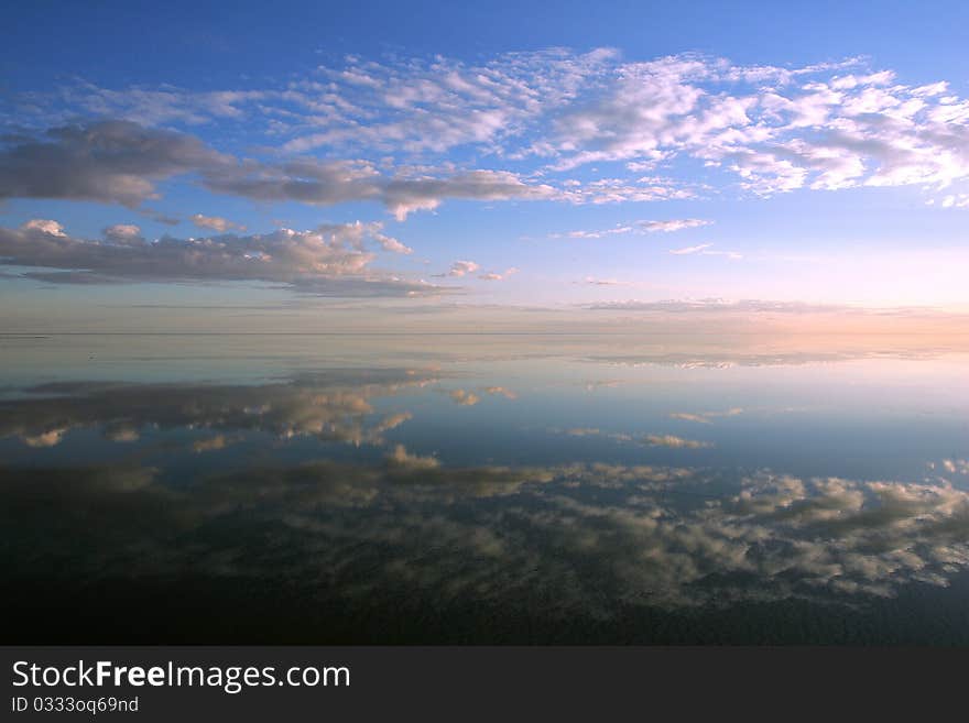 Sky and clouds reflectes in the water. Sky and clouds reflectes in the water