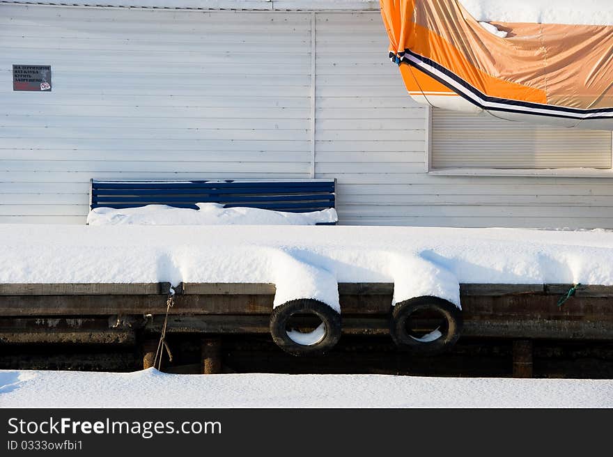 Snow-covered pier of yacht club. Snow-covered pier of yacht club