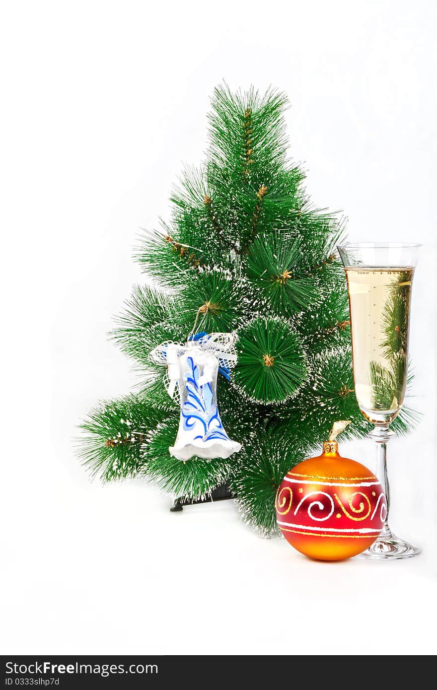 Christmas tree decorated with toys and a glass of champagne on belm background character of the New Year holiday