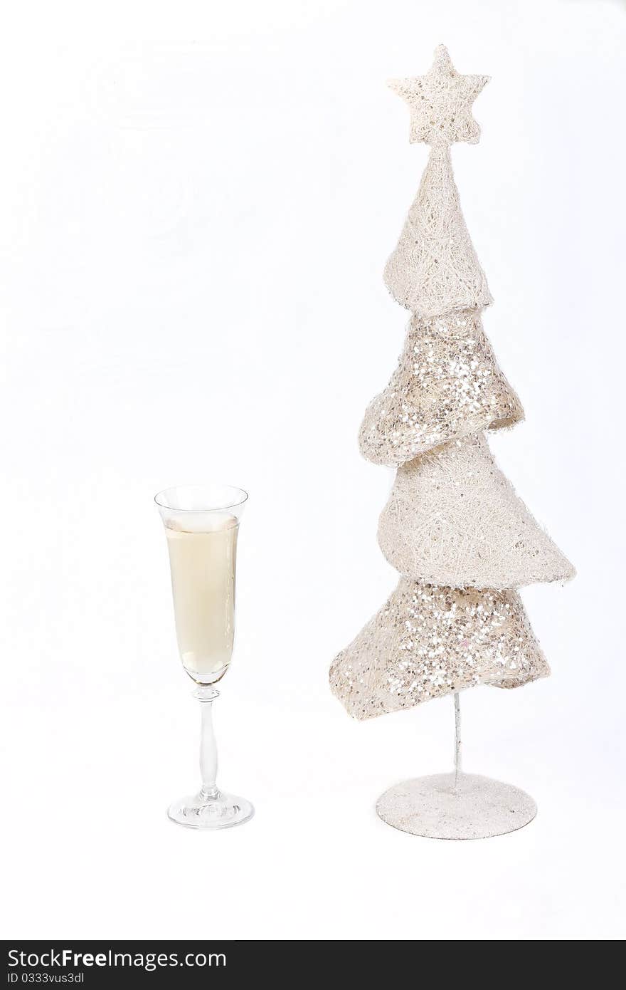 White Christmas tree and a glass of champagne on a white background symbol of Christmas and New Year