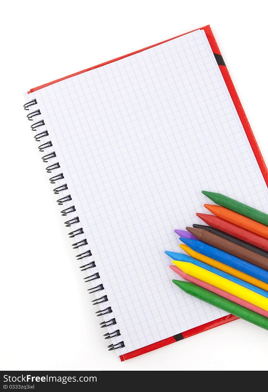 Wax color pencils on a notebook. Wax color pencils on a notebook