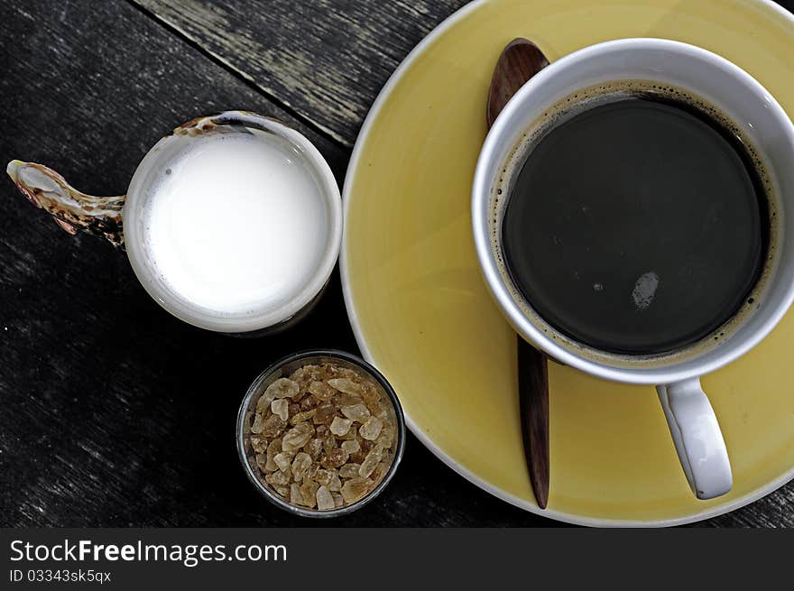 Coffee with milk and brown sugar over wooden. Coffee with milk and brown sugar over wooden