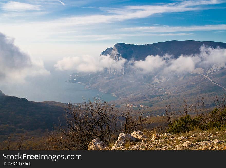 Clouds on a background of mountains and sea. Clouds on a background of mountains and sea