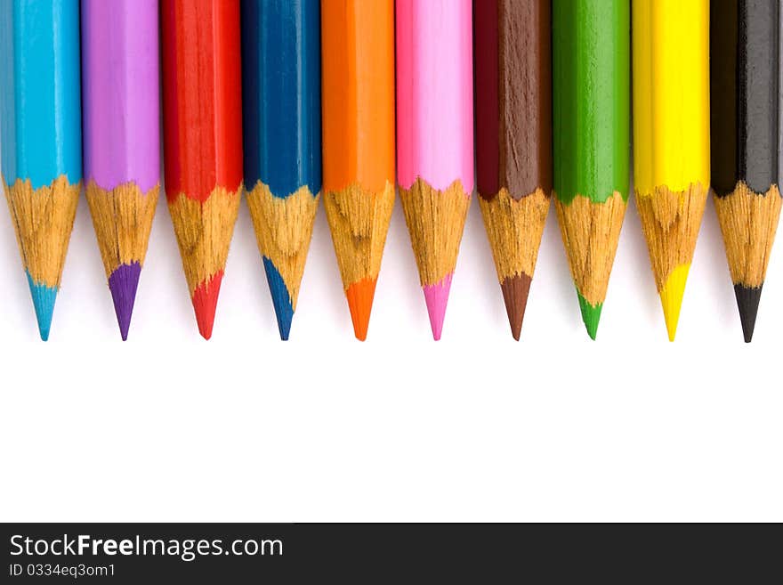 Pencils in a row on a white background.