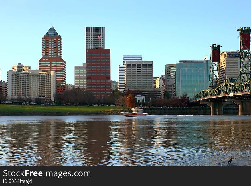 The Portland skyline at sunset with a passing boat. The Portland skyline at sunset with a passing boat.