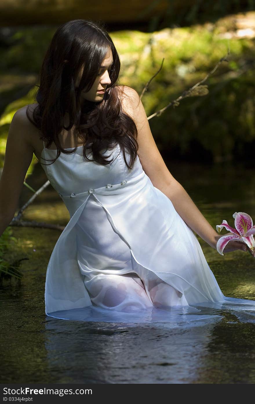 Young bride in stream in summer