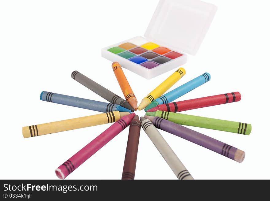 Colored wax pencils and a watercolor isolated on a on white background with clipping path