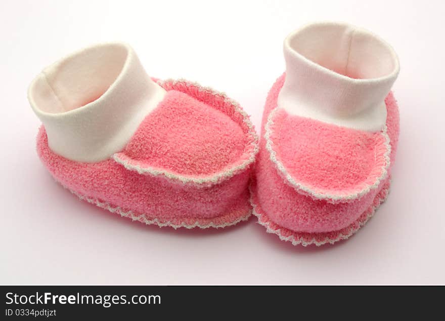 Red baby booties on a white background. Red baby booties on a white background.