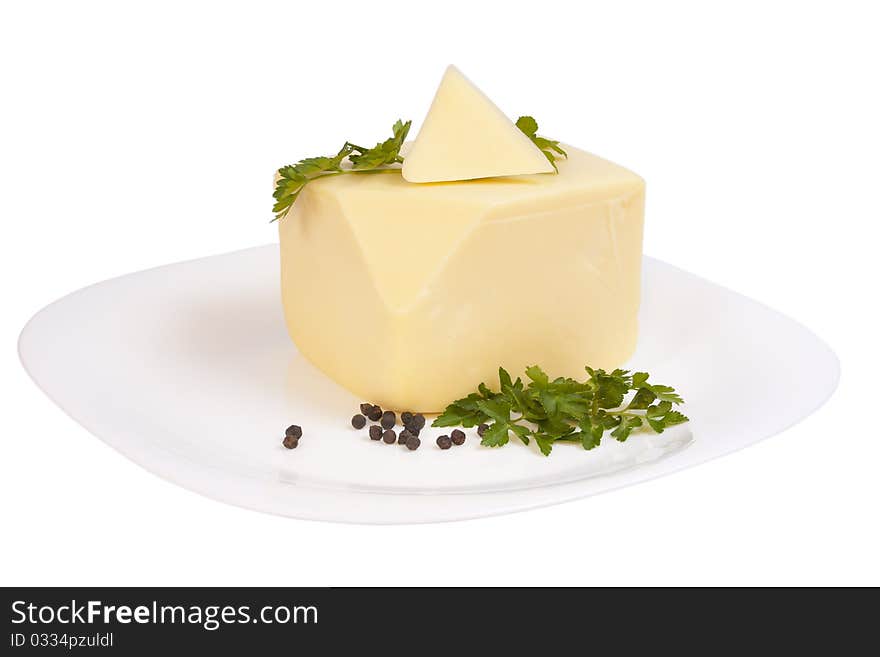 Cheddar cheese with parsley and pepper on a plate isolated over white background with clipping path