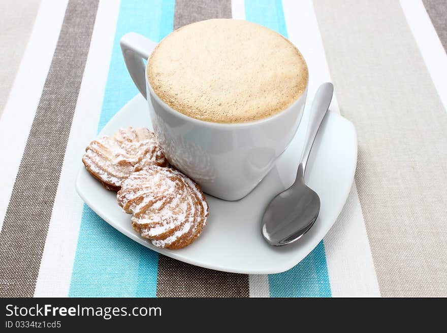 Cup with coffee and cookies